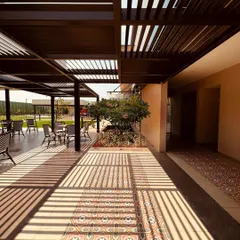 An architect's vision comes alive when shadows breathe life into the lines and angles. The pergola at our Brigade Valencia project creates a dynamic pattern on the floor, changing with the sun's movement.