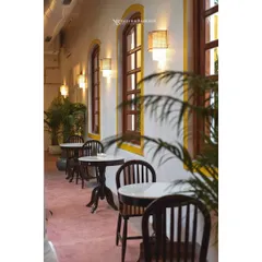 A bright, welcoming cafe corridor at Colocal. This shot emphasizes the clean lines, natural light from the large windows, and the airy atmosphere, perfect for showcasing a daytime spot.
