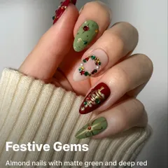 An example of our intricate festive artistry. These almond nails feature matte green and deep red bases, adorned with hand-placed festive studs for a truly unique holiday look.