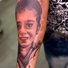 Portrait tattoos are a beautiful way to honor a loved one. I work from photographs to capture the exact likeness and expression, creating a timeless tribute like this portrait of a child.