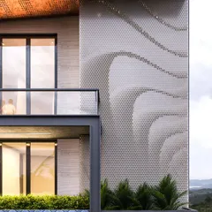 A close-up detail of a perforated metal facade with a flowing, wave-like pattern. This element adds an artistic and textural layer to the building's exterior while providing a degree of transparency.