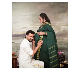 A beautiful moment of connection where the father-to-be listens to the baby's heartbeat. This pose is especially poignant in our traditional setting, blending a modern sense of intimacy with the timeless elegance of a classic Indian portrait.
