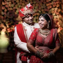 Capturing the pure, unscripted joy of a wedding day. This candid photo shows the bride's infectious laughter as her groom holds her close, a perfect memory of their happiness.