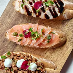 A trio of my signature bruschetta, straight from my highly classified recipe book. Toppings include smoked chicken, salmon with capers, and minced meat with mozzarella.