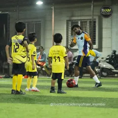Coaching is about connection. Here, I'm breaking down a drill for my youngest players, making sure they understand the 'why' behind the 'what'. I believe individual attention is key to building a strong foundation.