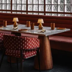 A detail of the custom furniture at Idylll. The hammered copper table base, marble top, and patterned upholstery reflect our commitment to craft and materiality in every aspect of the design.