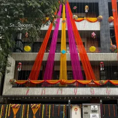 Here is the same house during the day. The vibrant drapes in pink, orange, and yellow make the building look festive and ready for a wedding celebration.