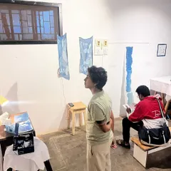 Visitors admiring the final artworks displayed at the end of our weekend photography and cyanotype workshop. The studio transforms into a gallery showcasing the participants' creations.