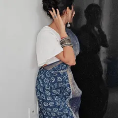 A detailed look at a messy bun hairstyle, perfect for a modern ethnic look. This style adds texture and volume while keeping the hair neatly tied up.