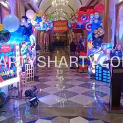 The adventure begins at the entrance with our Avengers-themed decor. Guests are greeted by life-sized cutouts of Superman and Captain America, an archway with Iron Man and Hulk balloons, and a personalized welcome sign.