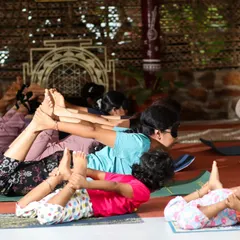 It's a joy to see participants of all ages practicing yoga together. Here, a group including children engages in Dhanurasana (Bow Pose) during our family-friendly Atmarpan Retreat, showing that yoga is for everyone.