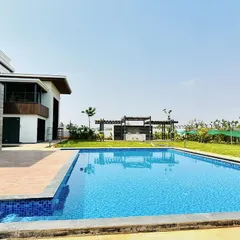 This angle highlights the pool's relationship with the surrounding landscape and future development areas like the pergola and outdoor kitchen. We plan our projects to accommodate all elements of your outdoor vision.