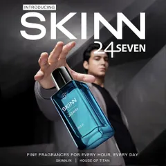 A commercial product shot for Skinn by Titan's fragrance line. The composition uses forced perspective to make the bottle the hero, while the model in the background provides a human element.