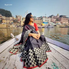 Style is a journey, not a destination. Here, on a boat in the serene ghats of Varanasi, a timeless checkered saree tells a story of heritage and grace. I help you find outfits that honor your roots while feeling completely modern.