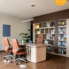 This executive cabin at the Brandman project is where power meets presence. We designed a space that balances authority with personal comfort, using rich textures, herringbone flooring, and custom shelving to create a sophisticated and productive environment.
