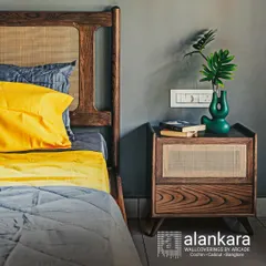 A close-up of the bedside table accompanying the cane headboard bed. The table continues the theme with a cane-fronted drawer and solid wood construction, creating a cohesive bedroom set.