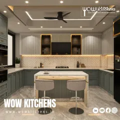 We designed this kitchen to feel like pure luxury. It features sage green shaker cabinets, a marble-topped island with seating, a herringbone tile backsplash, and integrated appliances for a clean, high-end look.