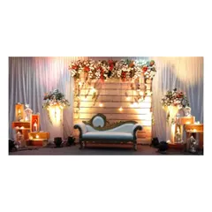 We love creating rustic yet elegant themes. This stage uses a wooden panel backdrop, warm Edison bulbs, and lush floral arrangements to create a cozy and stylish atmosphere perfect for a reception or engagement party.