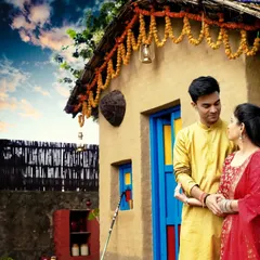 A rustic and romantic pre-wedding shoot. The village-themed backdrop and traditional attire create a unique and charming story for this couple.