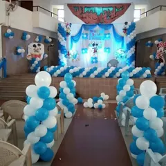 A large-scale hall decoration for a Mickey Mouse themed party, including an entrance path lined with balloon pillars.