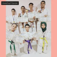 Our team of karateka winners from the Open Karate Championship. Seeing students of all belt levels, from green and yellow to brown, standing together with their awards is the best reward for an instructor.