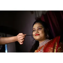 A behind-the-scenes moment of me applying the final touches to the bride's reception makeup. A bold red lip is the perfect finishing touch for a glamorous evening look.