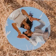 An award-winning pre-wedding shot that plays with perspective. Using a mirror, I captured the couple's reflection against the sky, creating a unique and artistic portrait that symbolizes their world together. This is the kind of creative photography I love.