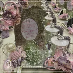 A closer look at the baby announcement hamper for a precious little girl. The personalized frame, delicate floral accents, and silver trinkets make it a gift to be cherished forever.