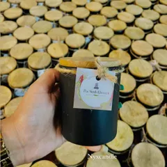 This is an example of our white-labeling service, where we produce products for other brands like The Sixth Element. This black jar candle with a wooden lid and custom tag shows how we can help you launch your own line of scented candles.