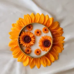 A creative shot of the Sunflower Urli, framed by real sunflower petals to show its inspiration.