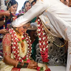 A beautiful moment during the mangalsutra ceremony, capturing the groom's focus and the bride's serene expression.