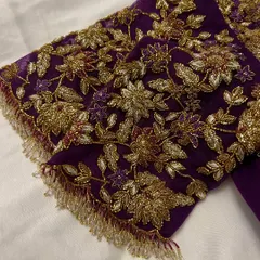This purple net blouse was a joy to create for my dear client Sowmya's baby shower. The sheer sleeves are adorned with delicate, hand-embroidered floral vines in gold threadwork, creating a look of ethereal elegance for her special day.