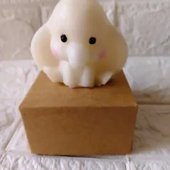 A single, adorable baby elephant candle made from soy wax. This is one of my most requested items for baby shower return favors, shown here with its individual gift box.