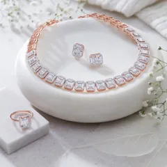 This shot showcases a full set of Orra jewelry, including a necklace, ring, and earrings. The clean, white props and delicate flowers create a soft and elegant setting that lets the diamonds take center stage.