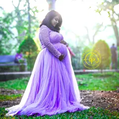 The mother-to-be cradling her bump in a beautiful lavender gown I provided for the shoot. The delicate pearl work on the sleeves adds a touch of elegance.