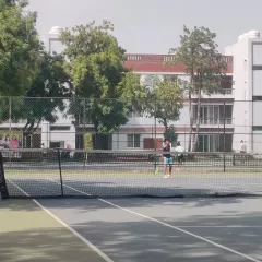 A wide shot of the action during the TPL-ITA Tennis Tournament hosted at our academy, with players competing on our hard courts.