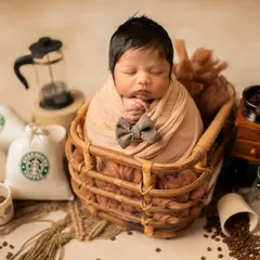 This little gentleman is perfectly posed with a tiny bow tie. The details in this coffee-themed newborn session make it a truly memorable one.