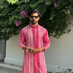 Add a splash of color to your wardrobe with this festive pink striped kurta. Paired with classic white trousers, it’s a stylish and comfortable option for celebrations like Raksha Bandhan or other family gatherings.