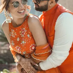 A candid shot of the couple sharing a laugh during their outdoor Mehndi ceremony in Delhi.
