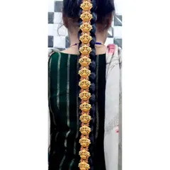 A traditional South Indian 'Jadai Billai' hair ornament, designed to decorate a long braid. This piece is crafted with temple-style motifs.