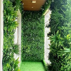 We can cover every surface to maximize the green effect. This narrow balcony was fully enveloped with artificial greenery on the walls and ceiling, creating an immersive, tunnel-like garden experience.