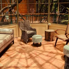 Our beautiful glasshouse is a serene, sun-drenched space perfect for quiet conversations, reading, or simply enjoying the view of the surrounding greenery.