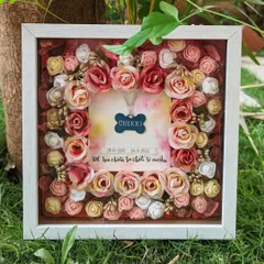 This floral shadow box was created to preserve a beloved pet's memory forever. I designed it to hold the pet's locket, surrounded by handcrafted flowers, making it a deeply personal and beautiful keepsake.