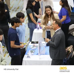 A student and his family engage in a detailed conversation with a university admissions representative. We encourage parents to be part of the college guidance process, facilitating informed family decisions.