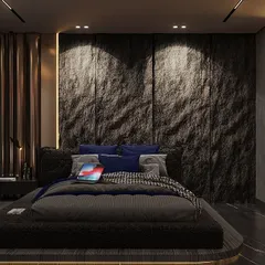 For this moody bedroom, we used a raw, dark stone feature wall, dramatically lit to highlight its texture. The low-profile bed adds to the grounded, cocooning feel of the space.