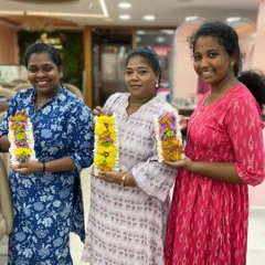 Students proudly displaying the beautiful flower garlands they learned to make in our styling class. This is a valuable add-on service for bridal clients.