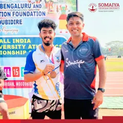 Yash Khanvilkar with his coach after winning the bronze medal in the Long Jump event at the 85th AIU Athletics Championships.