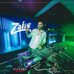 Posing by the console at the NYE 2025 party. The stage setup with the massive LED screen behind me was incredible.