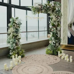 A beautiful and intimate proposal setup by the sea. I created a stunning floral arch and scattered candles to create a romantic ambiance, ensuring every detail was perfect for this special moment.
