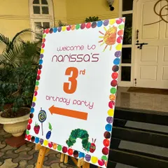 Welcome to the party. I coordinate with decorators to ensure my food setup, including signage, matches the overall theme, like this 'Very Hungry Caterpillar' birthday.